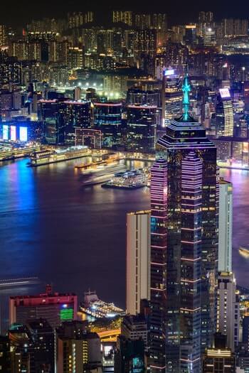 photo of sky scrapers and bay in Hong Kong at night