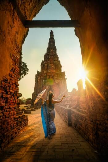 photo of a woman dressed in Thai costume in a temple in Thailand